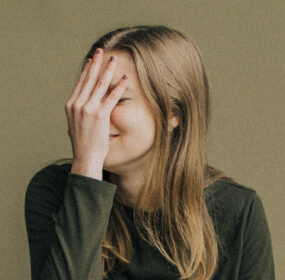 a girl hiding face with her hand